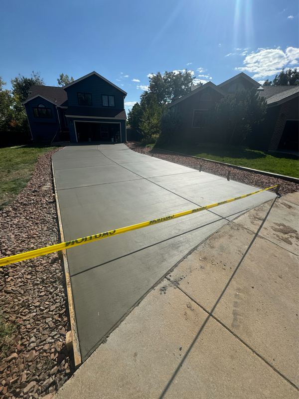 The same driveway after replacement, freshly poured and taped off to cure