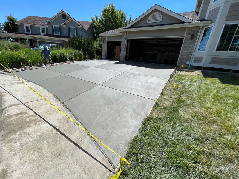 New concrete driveway apron meeting the existing city sidewalk
