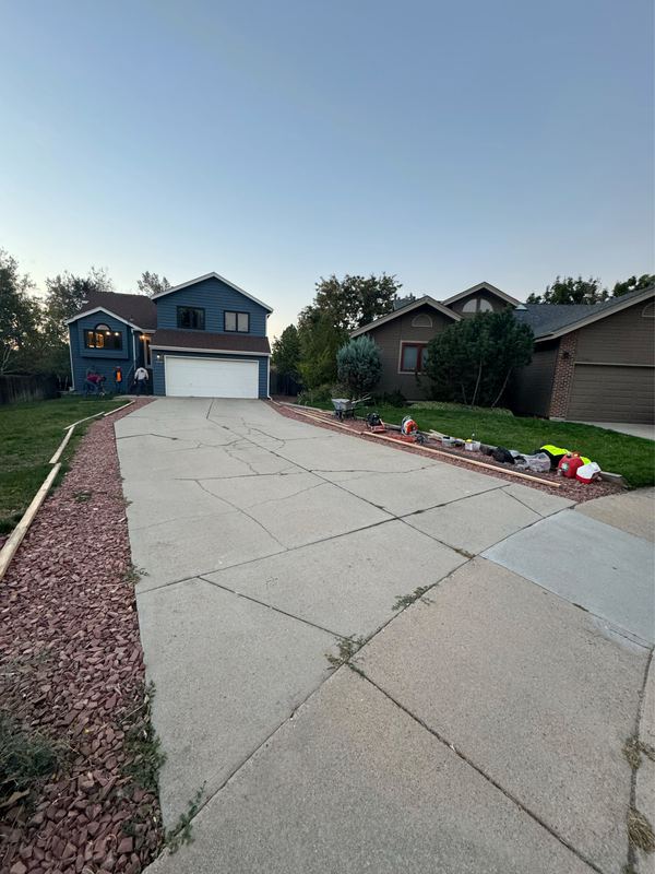 Cracked and settled concrete driveway before replacement