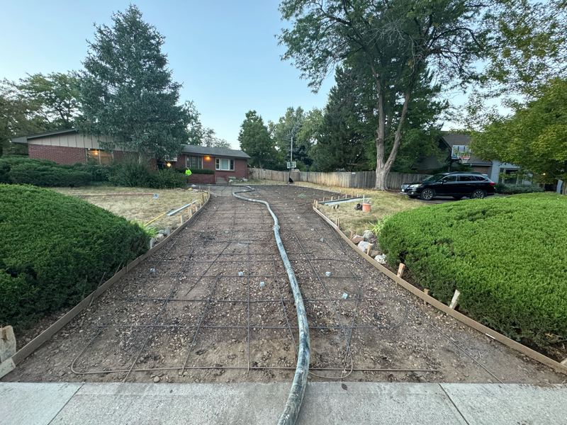 Reinforcing grid tied out over a compacted base before the driveway pour