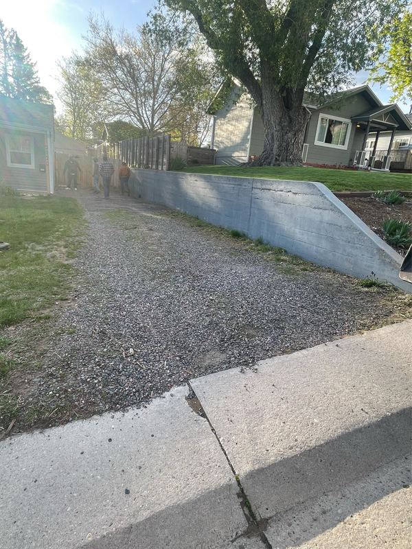 Gravel strip and retaining wall as found, before the new driveway was poured